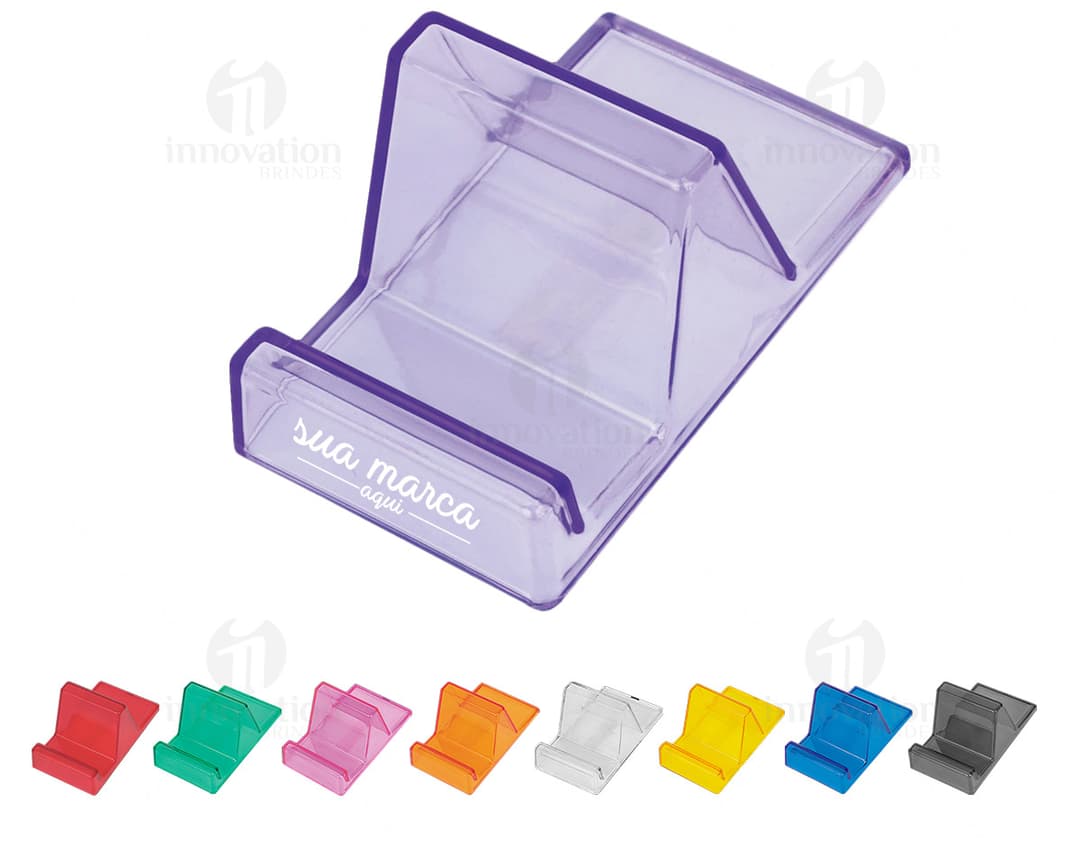 Suporte acrílico para celular em um escritório com computador, notebook, lápis, tela digital e outros equipamentos de escritório.