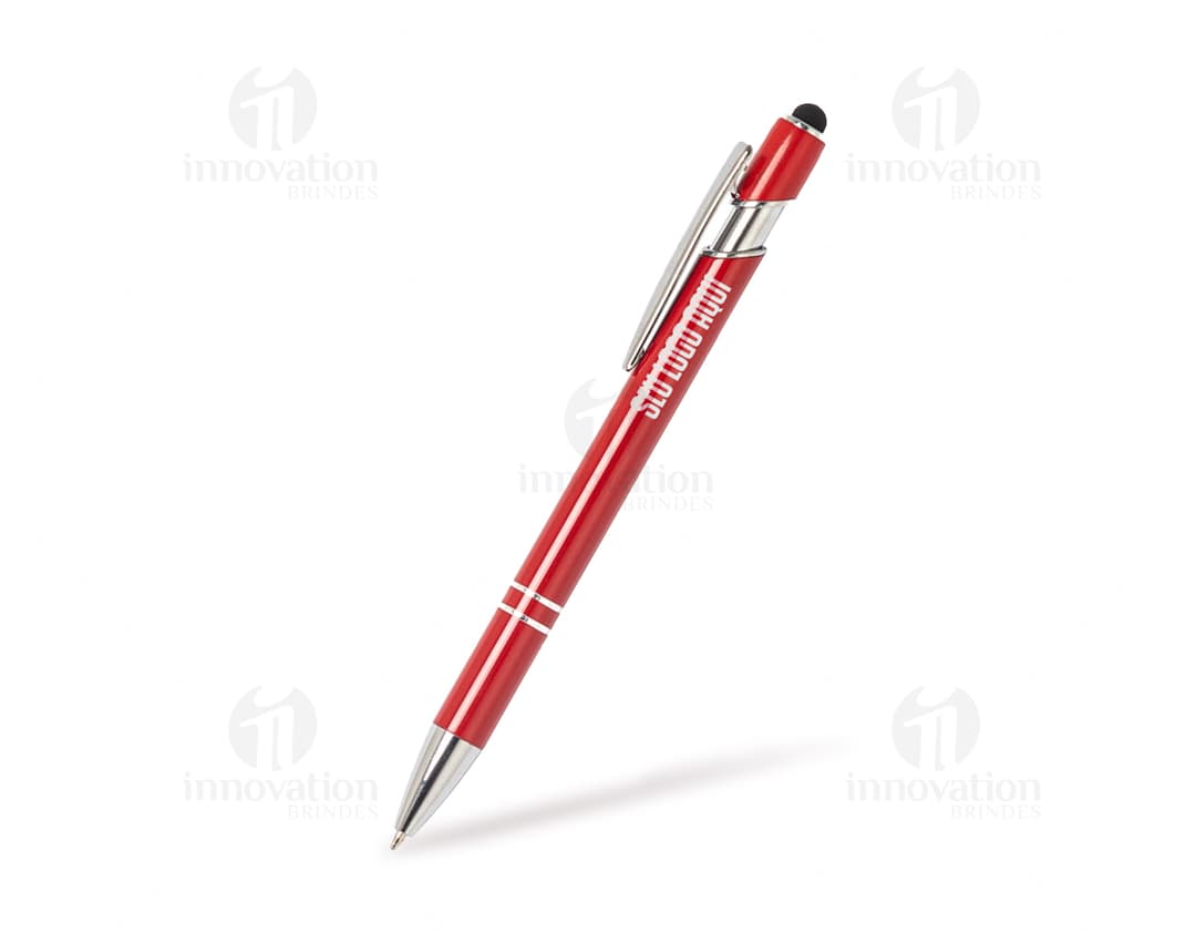 Caneta metal touch em diversas cores sobre uma mesa de escritório, ao lado de um bloco de notas, lápis e papel.