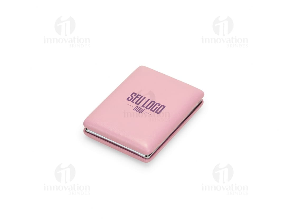 Espelho Duplo PU em um ambiente de escritório com notebook, paper, book, videodisk, e outros itens de escritório ao redor.