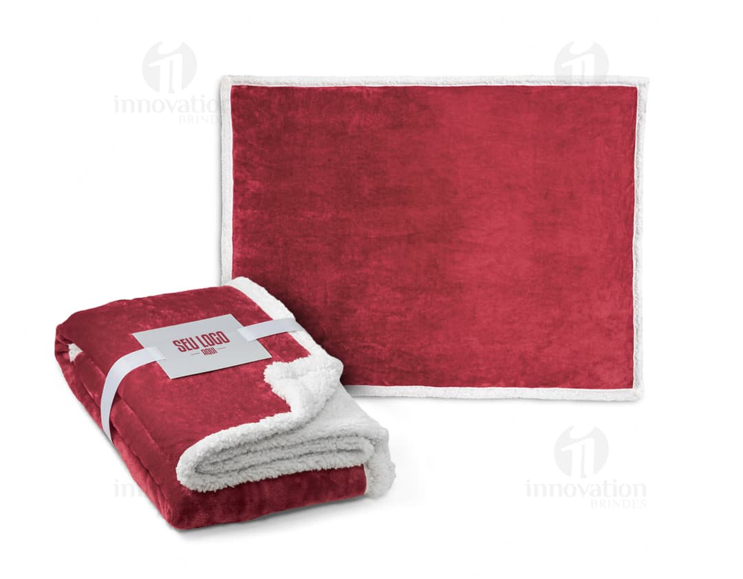 Manta polar 190 g/m² em embalagem de papelão marrom vazia, aberta, com laço de fita.